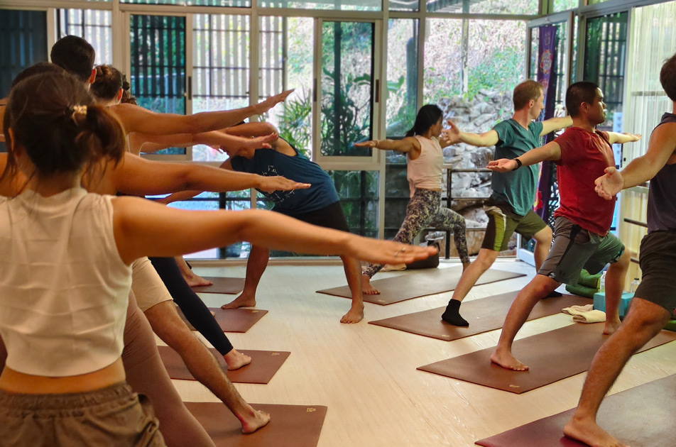 mixed group of people doing yoga poses on their mats at samadee yoga studio in aonang krabi
