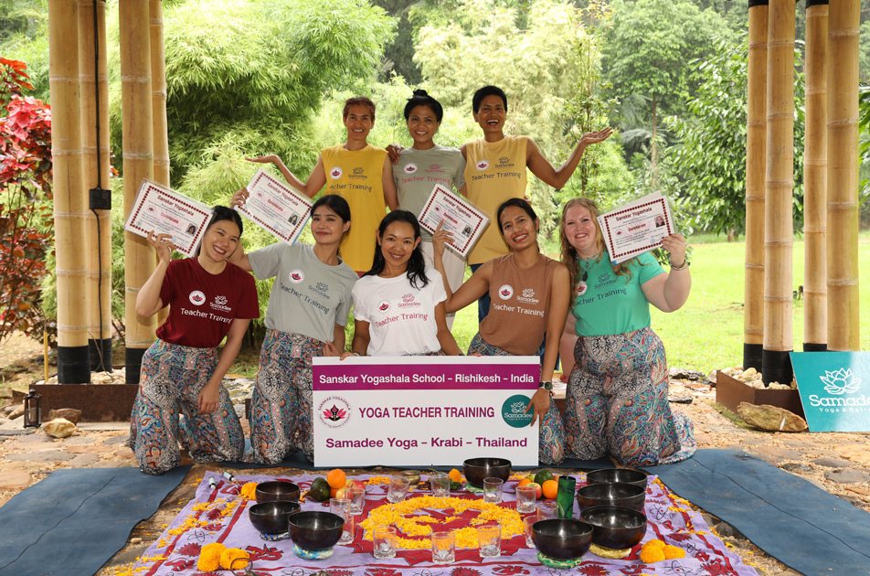happy students receiving their yttc instructor certifications from their samadee yoga teachers